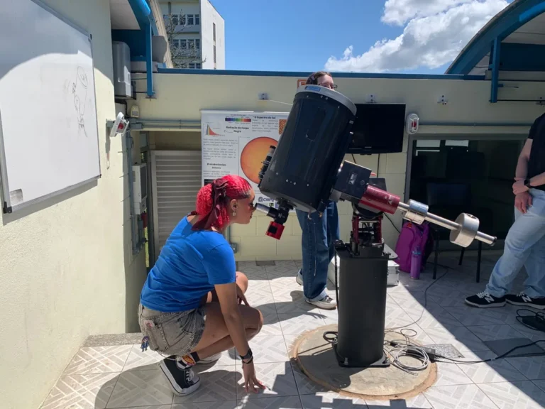 Estudante observa o céu pelo telescópio do Observatório Astronômico da UFSC durante visita guiada na Sepex, em dia de sol